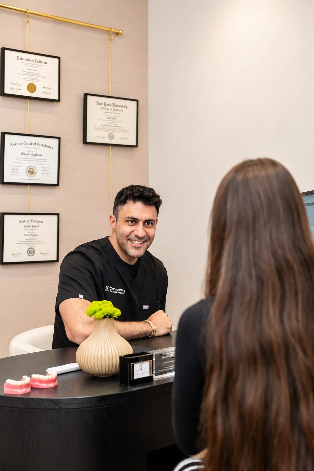 Kevin Cohenmehr, treatment coordinator, reviewing a treatment plan and fee with a patient at SC Orthodontics